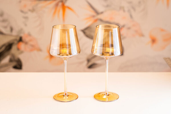 Pair of amber iridescent wine glasses.
