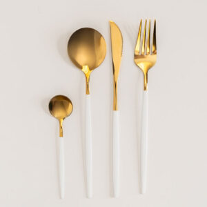 Gold & white cutlery rental set: spoons, knife, fork.