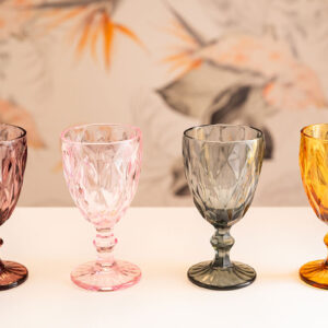 Four colored, patterned goblet glasses.