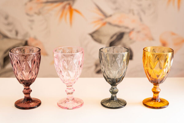 Four colored, patterned goblet glasses.